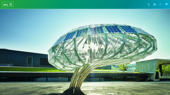 A modern solar tree sculpture with solar panels, set in a landscaped area.