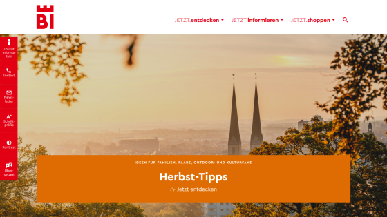 Tourism website with autumn tips for families, couples, outdoor and culture fans, featuring a cityscape with church towers at sunset