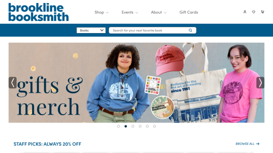 Brookline Booksmith website header with navigation, search bar, and hero section featuring gifts and merchandise with two people modeling apparel