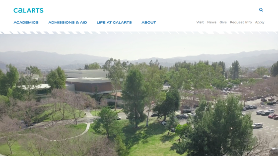 Overview of the CalArts campus with trees and parking area in view.