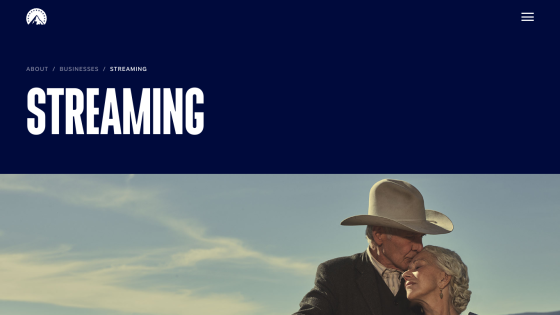 Streaming section with a couple embracing against a blue sky background.