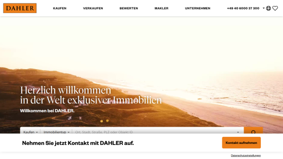 Real estate website welcoming visitors with a scenic coastal hero image and property search options