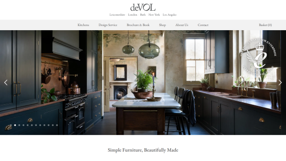 deVOL kitchen design website with dark cabinetry, marble table, pendant lights, and tagline Simple Furniture, Beautifully Made