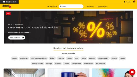 druck.at website showing a 10% Cyber Weeks discount banner and navigation with product categories and bestsellers