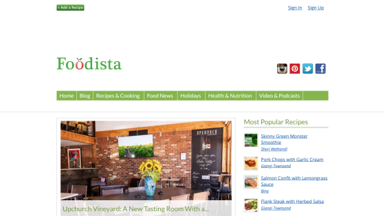 Foodista homepage featuring navigation menu, social media icons, and a hero image of a vineyard with sunflowers