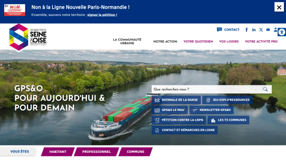 Grand Paris Seine & Oise community website with navigation, search bar, and a river cargo ship background
