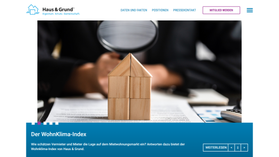 Haus & Grund website showing WohnKlima-Index with wooden house blocks and market assessment text