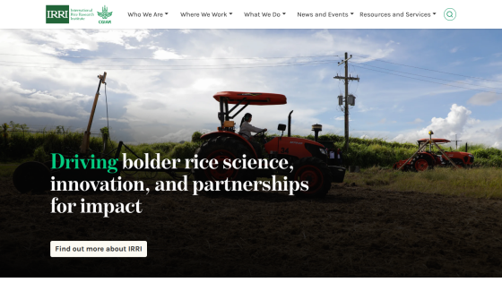Homepage featuring a tractor and text about rice science and partnerships.