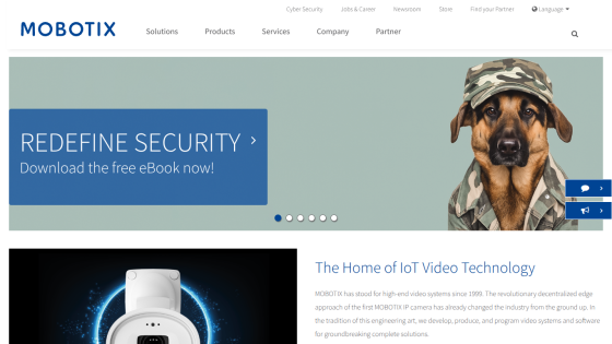 Website homepage featuring a security eBook download banner and an article on IoT video technology with a dog wearing goggles image