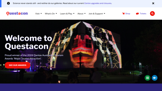 Questacon homepage with navigation, announcement of 2024 Qantas Australian Tourism Award, and night projection on building.