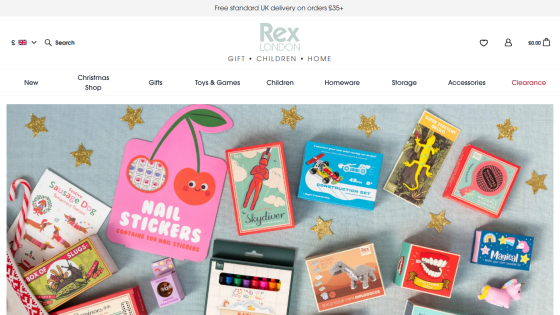 Rex brand website showing holiday-themed stickers and toys in the hero section with navigation menu