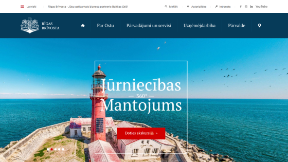 Rīgas Brīvosta website with navigation and hero section featuring a lighthouse and text about 360° tours