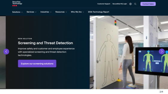 Technology company homepage featuring screening and threat detection with a call-to-action button and a photo of a woman walking past a security scanner