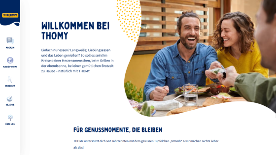 Welcome page of Thomy with navigation menu and smiling people enjoying food outdoors