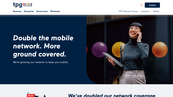 Promotional message about expanding mobile network coverage with a smiling woman holding a tablet.