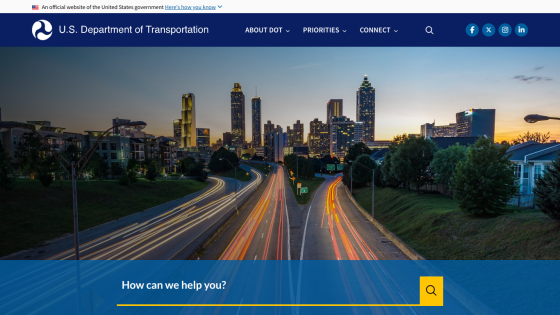 U.S. Department of Transportation homepage featuring a city skyline and a help prompt.