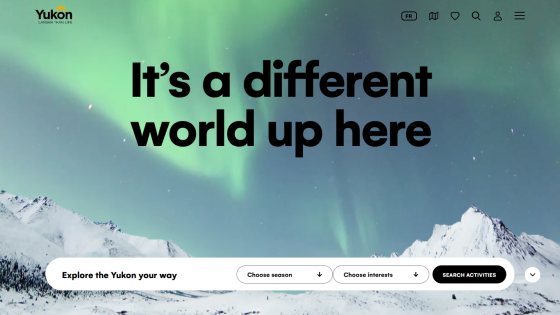 Yukon tourism homepage with headline 'It's a different world up here' and search options for season and interests