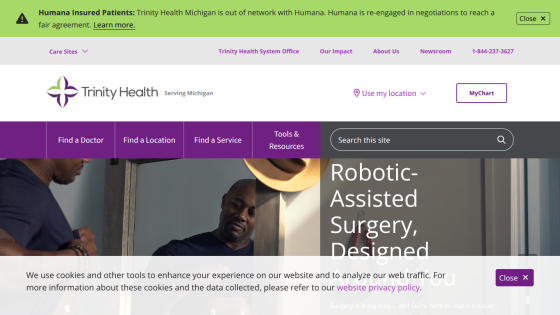 Trinity Health Michigan homepage with navigation, search bar, and hero section promoting robotic-assisted surgery.