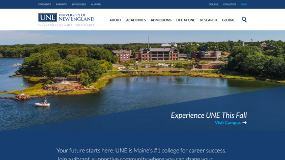 University of New England homepage featuring a scenic view and call to action for fall enrollment.