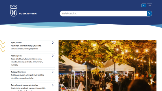 City website with navigation links for services, culture, work, and development alongside a night market scene with lights and people