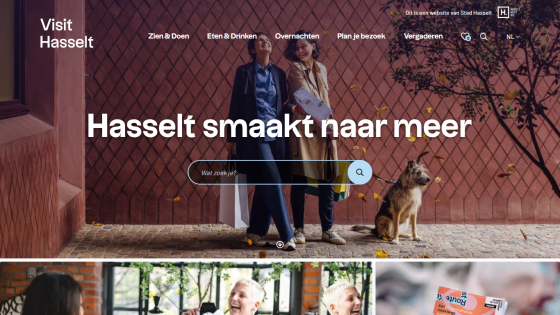 Tourism website for Hasselt with navigation menu, search bar, and hero image of two people and a dog