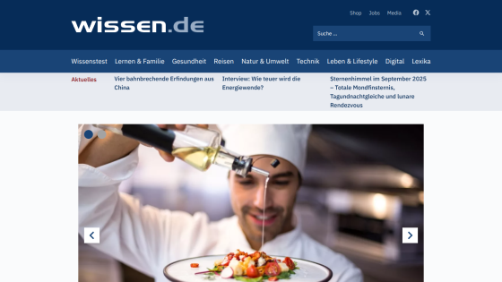Chef drizzling oil over a gourmet dish in a restaurant setting.