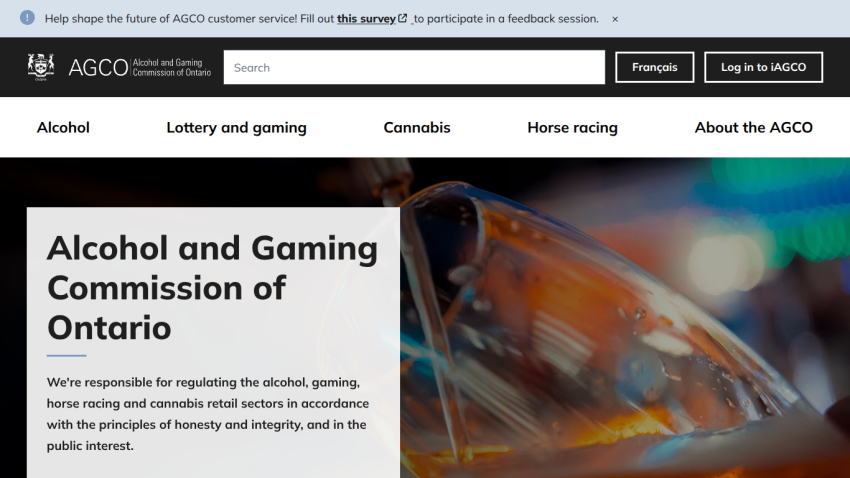Alcohol and Gaming Commission of Ontario homepage with navigation and hero image of a person pouring a drink