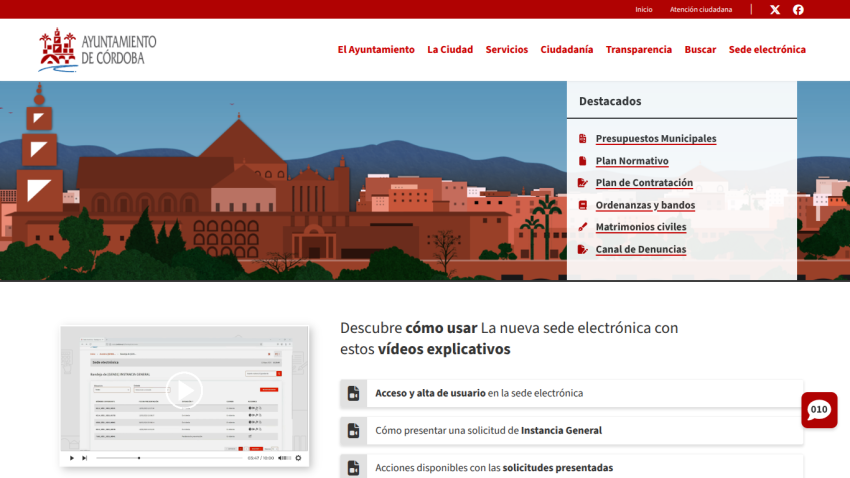 Ayuntamiento de Córdoba website with navigation menu, cityscape illustration, and links to municipal budgets and services videos