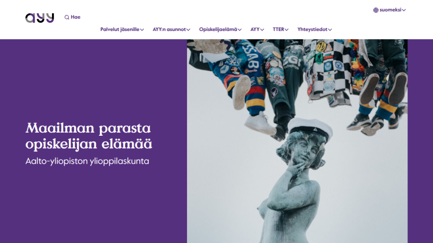 Aalto University Student Union homepage with navigation menu and hero text about student life alongside a statue wearing a student cap.