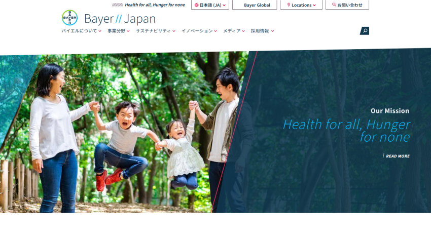 Bayer Japan website with navigation menu and hero image of a family playing outdoors, featuring mission statement 'Health for all, Hunger for none'