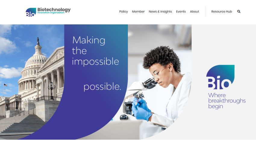 Biotechnology website featuring a Capitol building and a scientist at work, promoting breakthroughs.