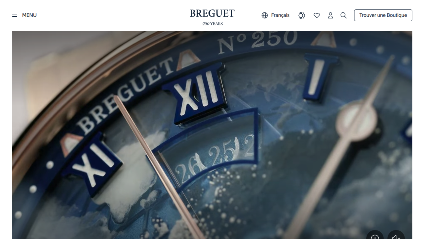 Close-up of a Breguet watch face showing Roman numerals and intricate details.