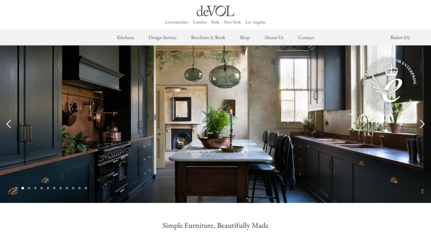 deVOL kitchen design website with dark cabinetry, marble table, pendant lights, and tagline Simple Furniture, Beautifully Made