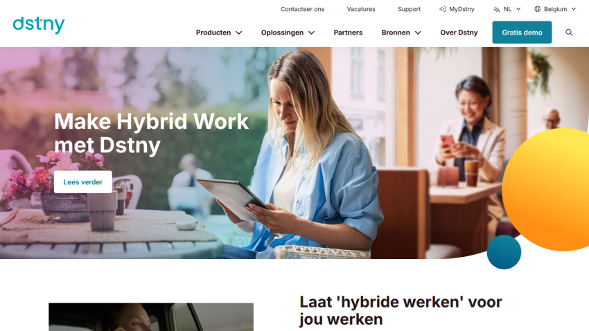 Dstny homepage with headline 'Make Hybrid Work met Dstny' and a woman working on a laptop in a cafe setting