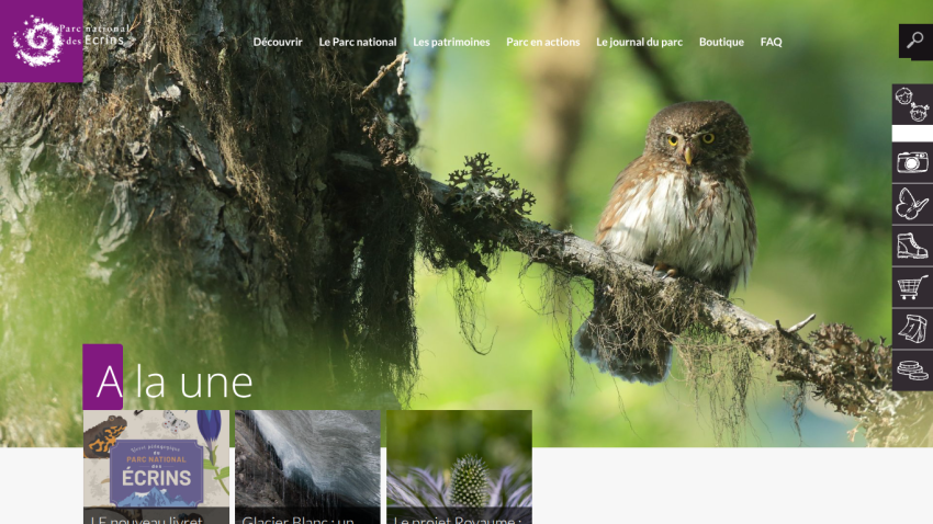National park website with mountain landscape, waterfall, and autumn trees under blue sky
