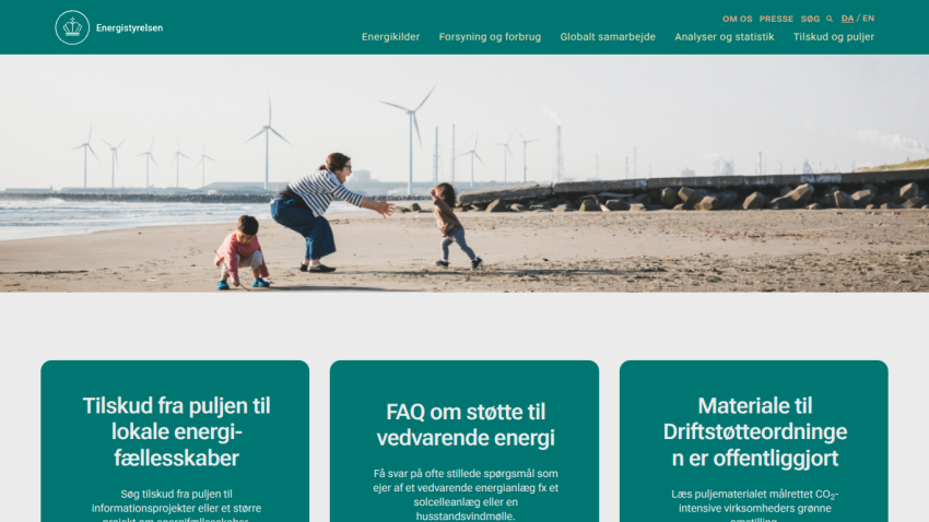 Website promoting local energy initiatives with a family on the beach and wind turbines in the background.
