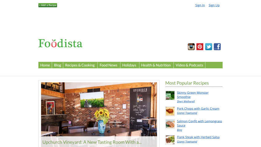 Foodista homepage featuring navigation menu, social media icons, and a hero image of a vineyard with sunflowers