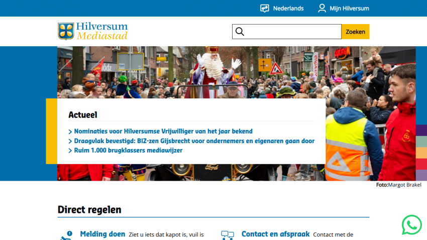 Hilversum Mediastad website with news headlines and a festive parade image in the hero section