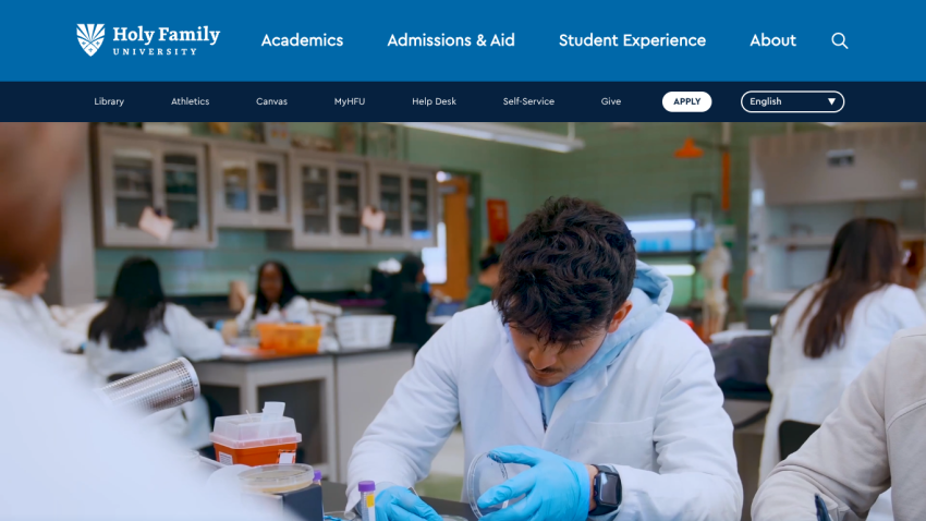 Holy Family University website header with navigation and a student in a lab setting in the hero section