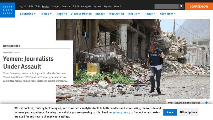 News release on journalists under assault in Yemen with a photo of a journalist in a damaged area.