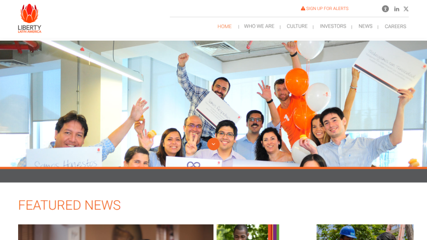 Website header with navigation and hero section showing a group of people celebrating with balloons and certificates