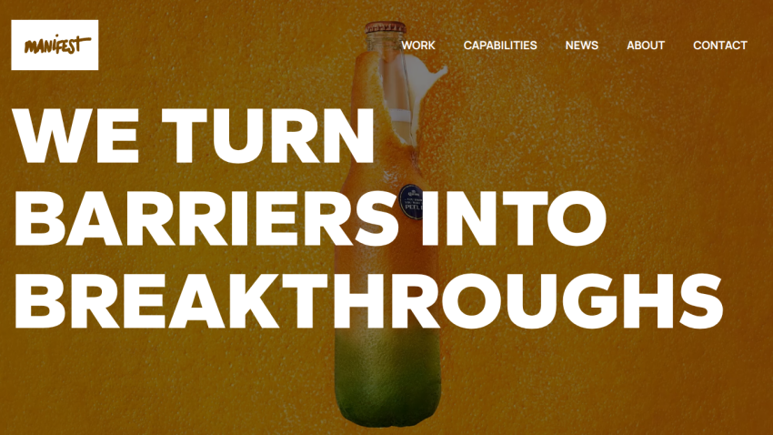 Manifest agency homepage with navigation and headline 'We turn barriers into breakthroughs' over a textured orange background