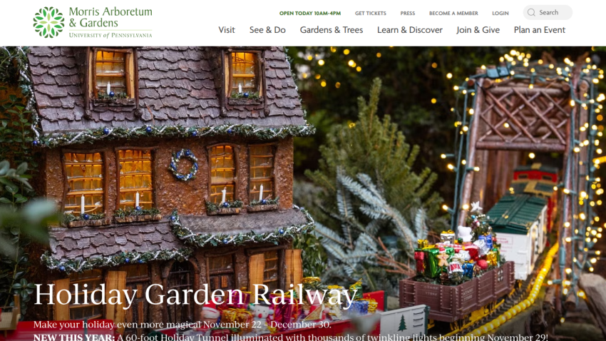 Morris Arboretum holiday garden railway event with a festive train and illuminated tunnel