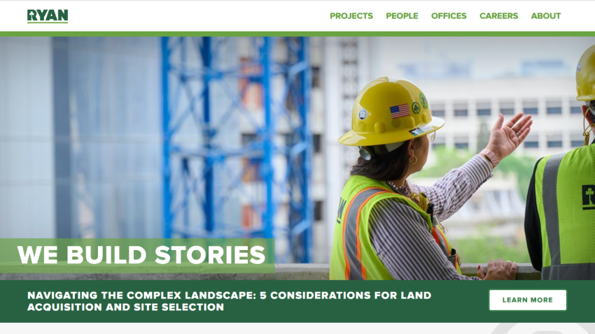Construction company website with navigation and headline 'We Build Stories' and article about land acquisition and site selection