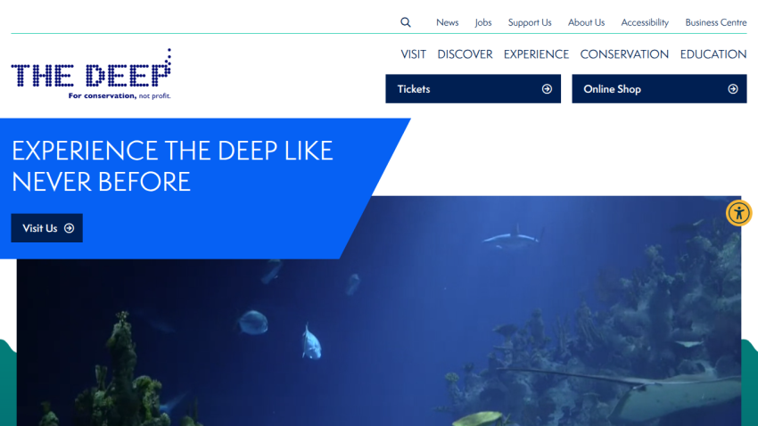 The Deep aquarium homepage with navigation links, call to action to visit, and underwater marine life hero image