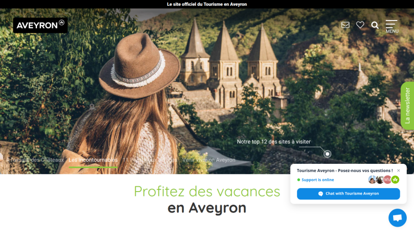 Tourism website header with logo, navigation, search, and hero image of woman with hat looking at church towers in Aveyron