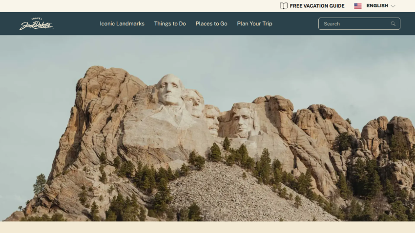 Mount Rushmore with a clear sky, featuring iconic presidential sculptures.