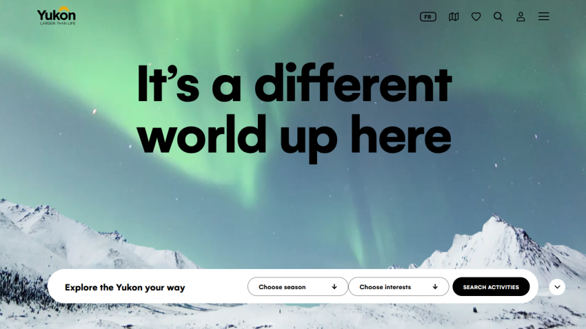 Yukon tourism homepage with headline 'It's a different world up here' and search options for season and interests