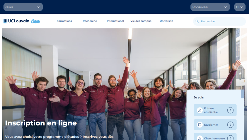 University website homepage featuring students celebrating with arms raised and registration information.