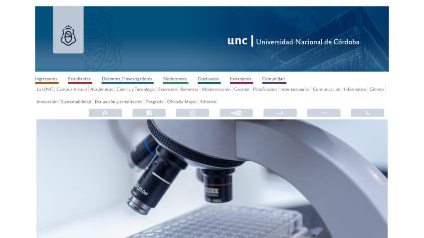 University National of Córdoba website with a microscope in focus and navigation links displayed.